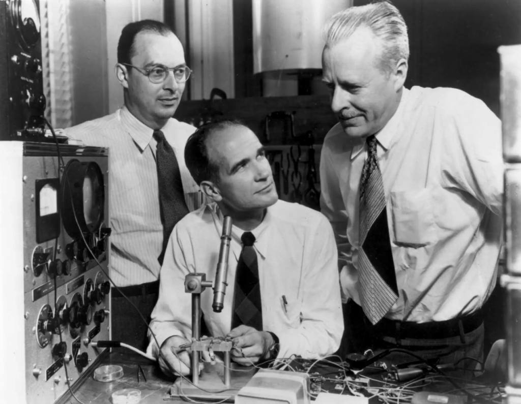 Photo of Bardeen, Shockley and Brattain with the first transistor.
